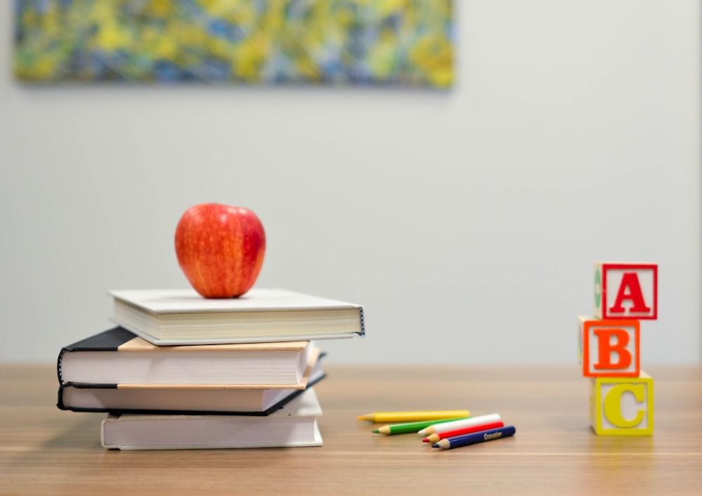 Books, colouring pencils and ABC blocks on a desk