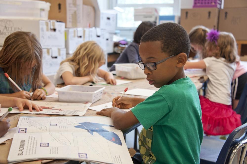 A young student writing carefully during a small-batch class